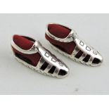 A pair of silver and red velvet pin cushions modelled as Roman sandals.