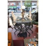 A cast aluminium garden bistro set comprising pierced rectangular table and a pair of elbow chairs