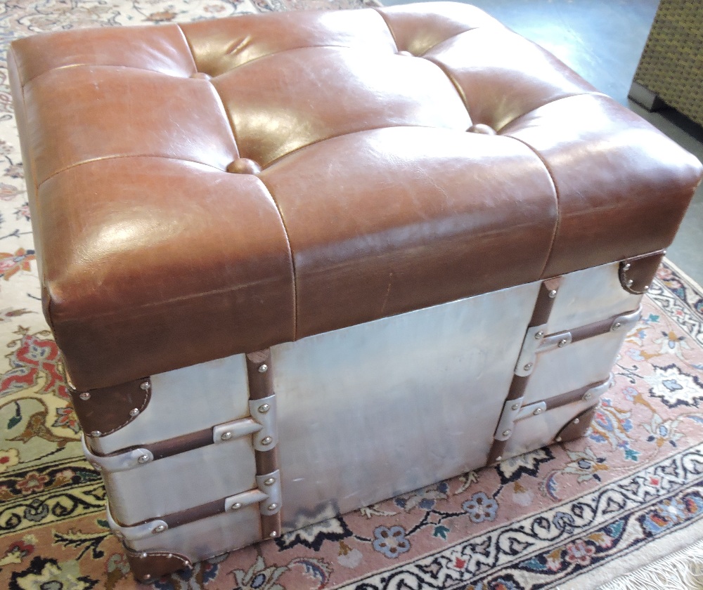 A pair of aviator style wood bound studded aluminium box seat stools with buttoned tan leather