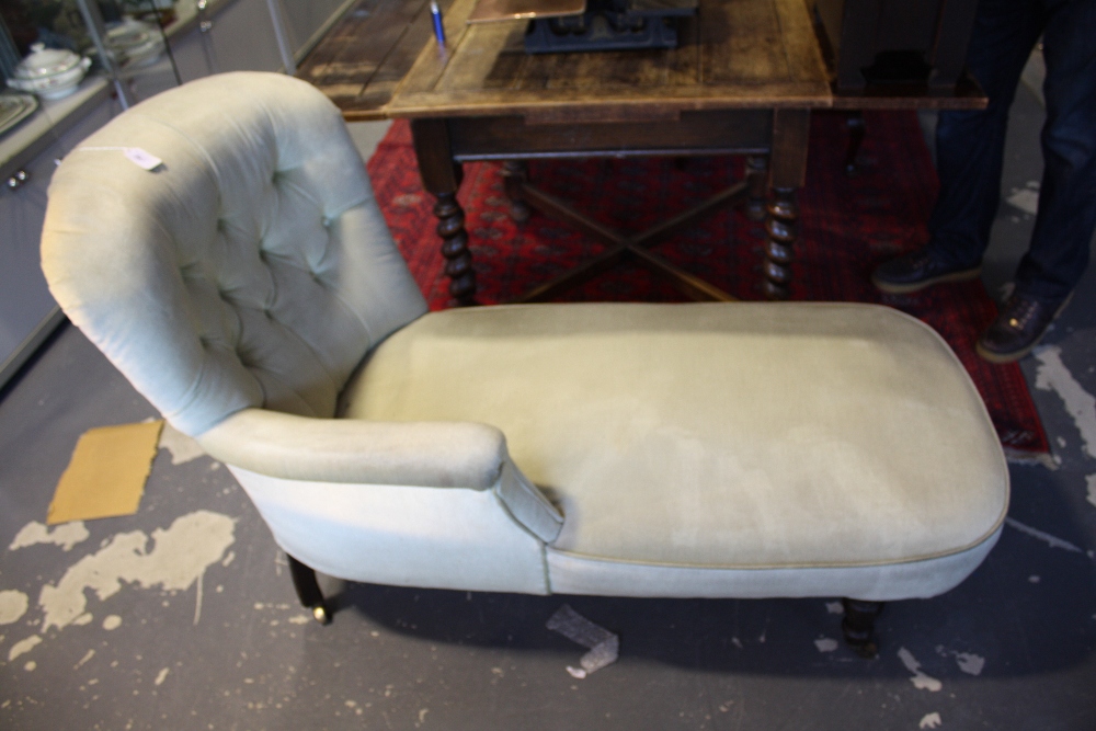 A late Victorian daybed upholstered in buttoned pale green draylon on turned baluster legs.
