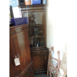 Mahogany corner cabinet with glazed upper section above cupboard,