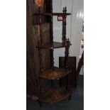 A late Victorian walnut and inlay four tier etagere,