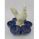 A French pottery egg tray, molded with a cockerel to centre, having six egg trays to side.