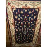 An Afghan blue ground Bokhara rug, decorated with flowers and foliage, multi-bordered and fringed.