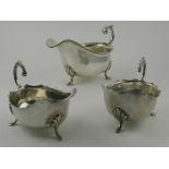 A silver plated sauce boats, raised on three feet,