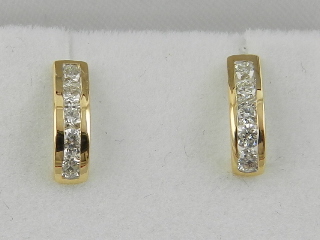 A pair of 18 carat yellow gold and diamond half hoop earrings, the stones of approx. 0.45 carats