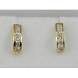 A pair of 18 carat yellow gold and diamond half hoop earrings, the stones of approx. 0.45 carats