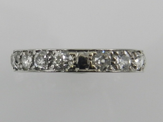 A white metal and diamond eternity ring, set with sixteen diamonds.