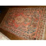 A Persian red ground Mahal rug, having central medallion on a floral ground, multi-bordered and