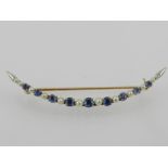 A yellow metal, sapphire and diamond set crescent brooch, the mount stamped 14K.