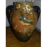 A large twin-handled majolica vase, decorated with a kingfisher flying amongst flowers. H.46cm