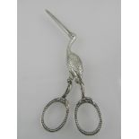 A pair of early 20th century white metal novelty scissor pulls,