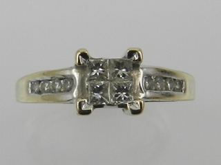 An 18 carat white gold and diamond ring, set four square cut diamonds of approx. 0.