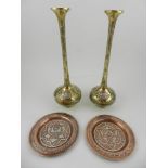 A pair of Middle Eastern brass trumpet vases, together with two copper trays. H.