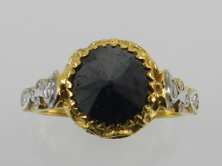 An unusual yellow metal and black diamond ring, the inverted stone of approx. 1.