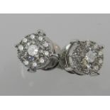 A pair of 18ct white gold diamond cluster ear studs, screw-back fittings, total weight 1ct.