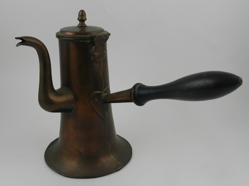 An English Art Nouveau copper hot chocolate pot, with turned ebonised wooden handle.