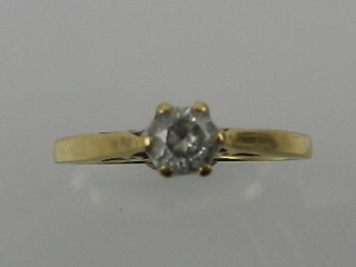 An 18 carat yellow gold and solitaire diamond ring, the stone of approx. 0.33 carats.