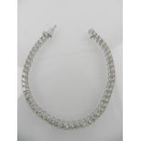 An 18ct white gold and diamond articulated line bracelet, modern claw set, weight 5.51ct.