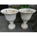 A pair of 19th century cast iron white painted urns. H: 64cm