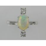 An 18 carat white gold, diamond, and opal set ring, the opal of approx. 1.35 carats, the diamonds of