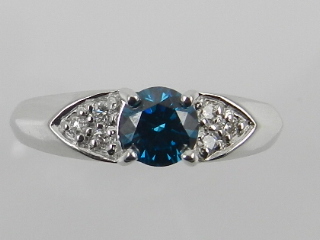 An unusual 18 carat white gold and diamond solitaire ring, set central blue diamond of approx. 0.