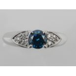 An unusual 18 carat white gold and diamond solitaire ring, set central blue diamond of approx. 0.