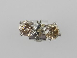 A pair of 18 carat white gold and collet set diamond stud earrings, the stones of approx. 0.