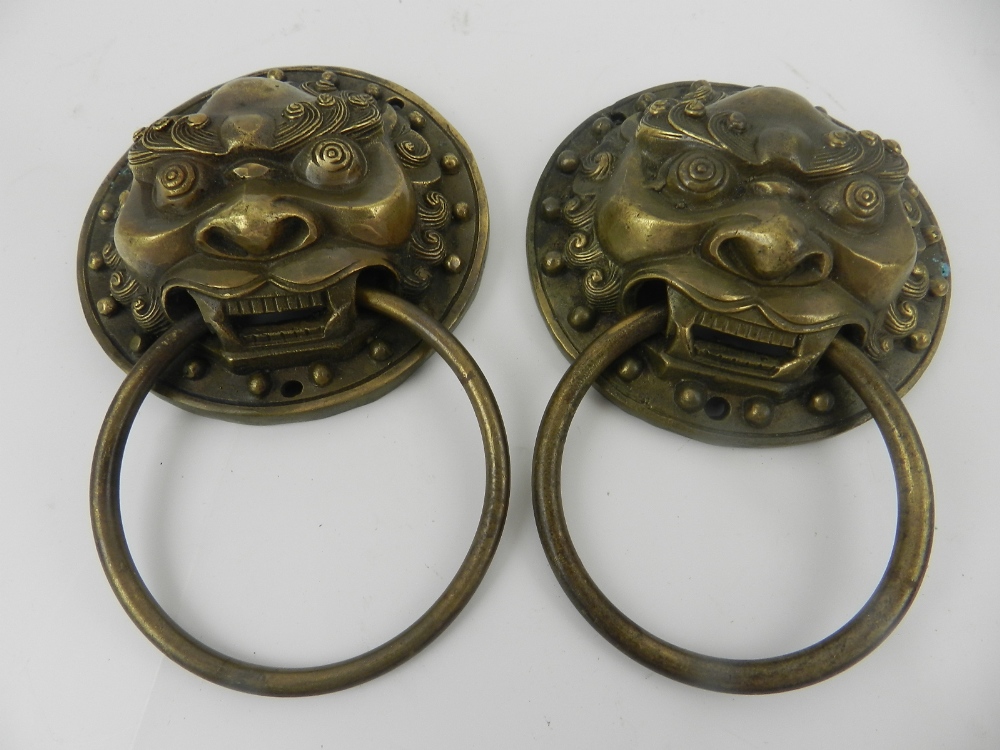 A pair of Chinese cast metal door knockers, modelled as dogs of Fo.