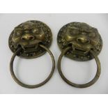 A pair of Chinese cast metal door knockers, modelled as dogs of Fo.