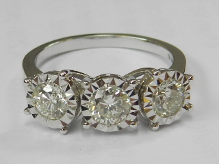 An 18ct white gold three-stone diamond ring, in high claw setting, total weight 1.02ct, size M.