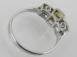 A white metal and three stone diamond ring, set central yellow diamond of approx. 0. - Image 2 of 2