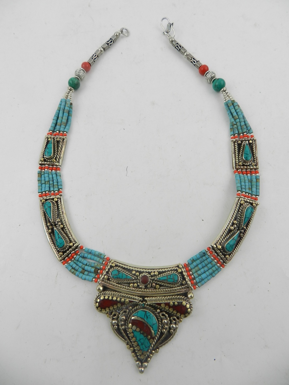 A white metal, coral, and turquoise beaded necklace, together with another similar three strand
