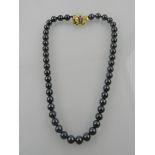 A hematite beaded necklace, with an 18 carat yellow gold clasp.