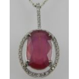 An 18 carat white gold, diamond, and treated ruby pendant, suspended on an 18 carat white gold