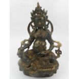 A Chinese cast metal study of a seated deity. H.