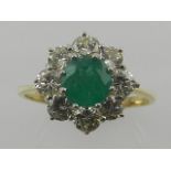 An 18 carat yellow gold, diamond and emerald cluster ring,