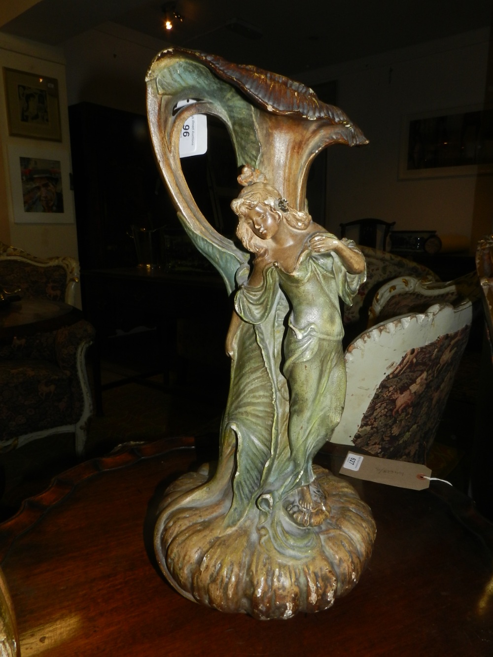 In the Art Nouveau style, a French spelter vase having floral decoration, raised on circular base H.