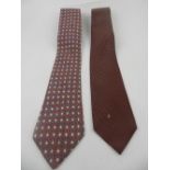 A Chanel tie, polka dotted maroon silk, together with Hermes tie (slight damage).