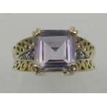 A 9 carat yellow gold and amethyst ring, set central square cut amethyst,