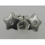 A pair of 18 carat white gold star-shaped stud earrings, set with solitaire diamonds,