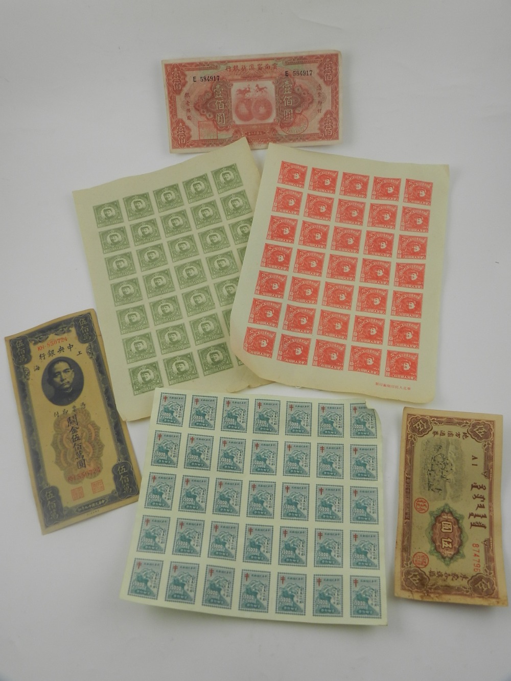 A collection of Chinese stamps and banknotes.