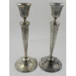 A pair of silver plated candlesticks, of Corinthian column form H: 21cm,