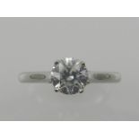 A platinum and solitaire diamond ring,