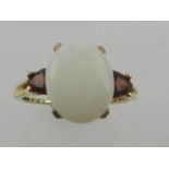 A 9 carat yellow gold, opal, and garnet ring,