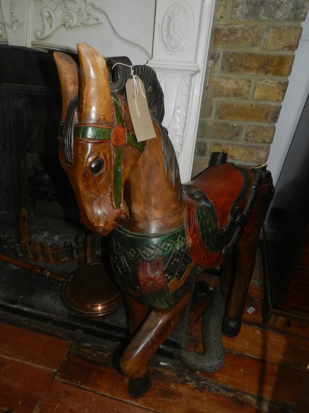 A pair of carved and painted hardwood horses.