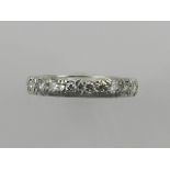 A white metal and diamond set eternity ring, the stones of approx. 1.2 carats combined.