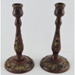 A pair of red stained baluster candlesticks, applied with summer flowers, H.