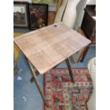 An early 20th Century oak folding student's desk together with a folding two tier tea trolley.