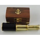 A miniature leather-bound brass two-drawer telescope, in wooded box,